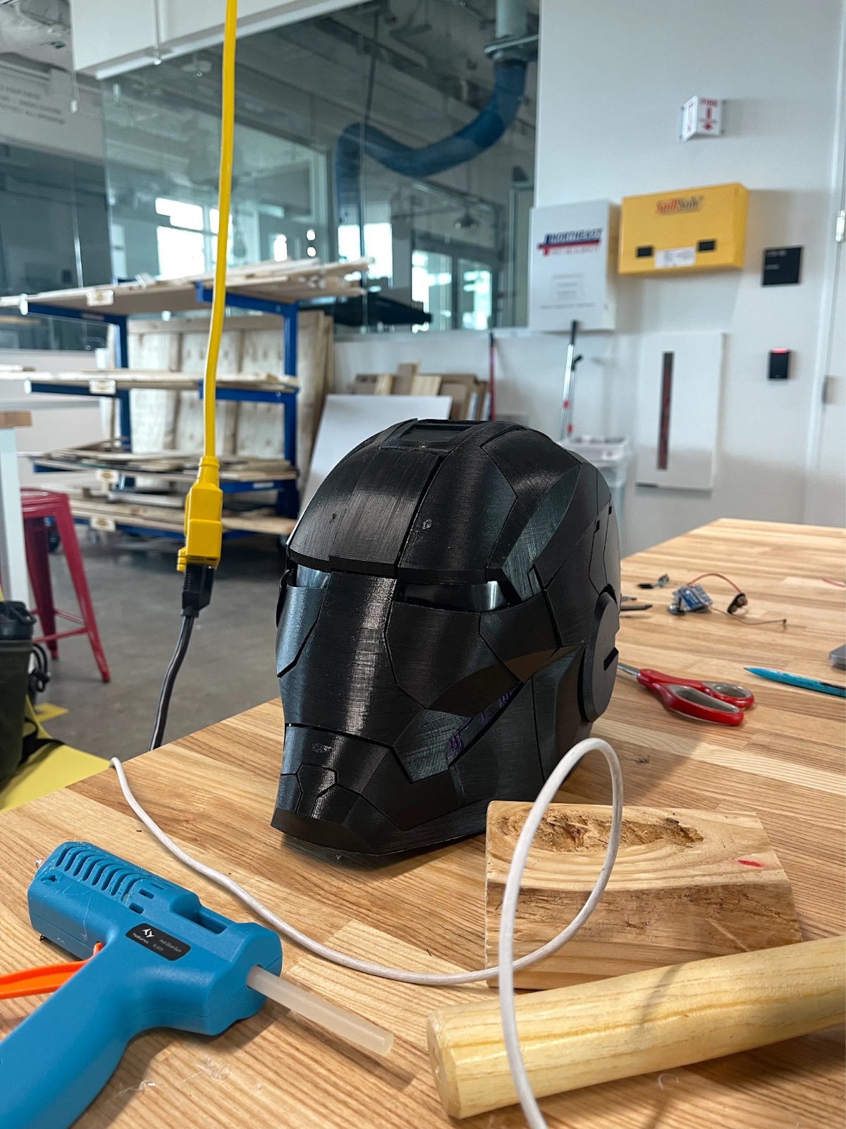A 3D-printed Iron Man helmet on a workbench