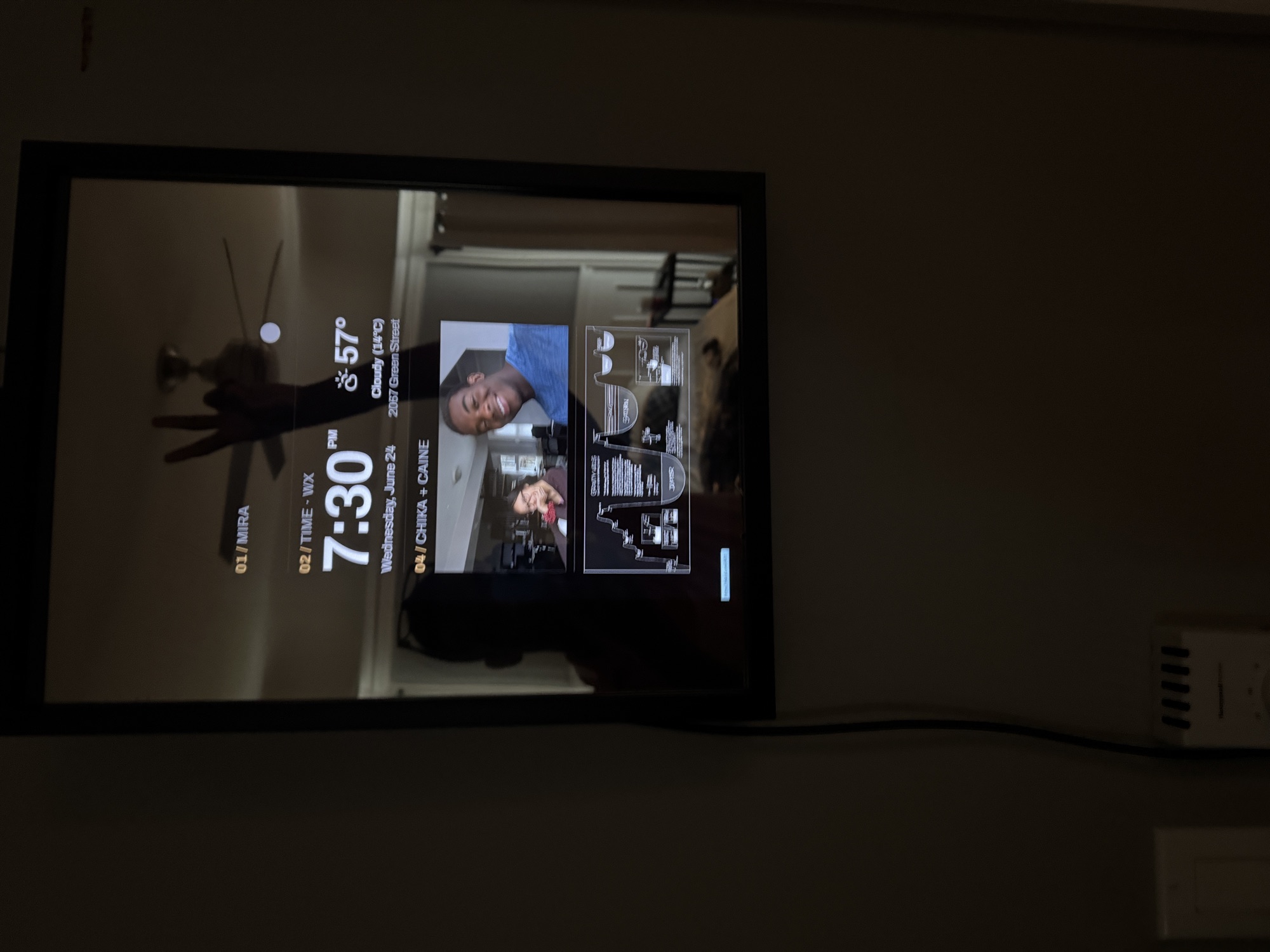 The smart mirror in the house, showing time, weather, and a photo widget