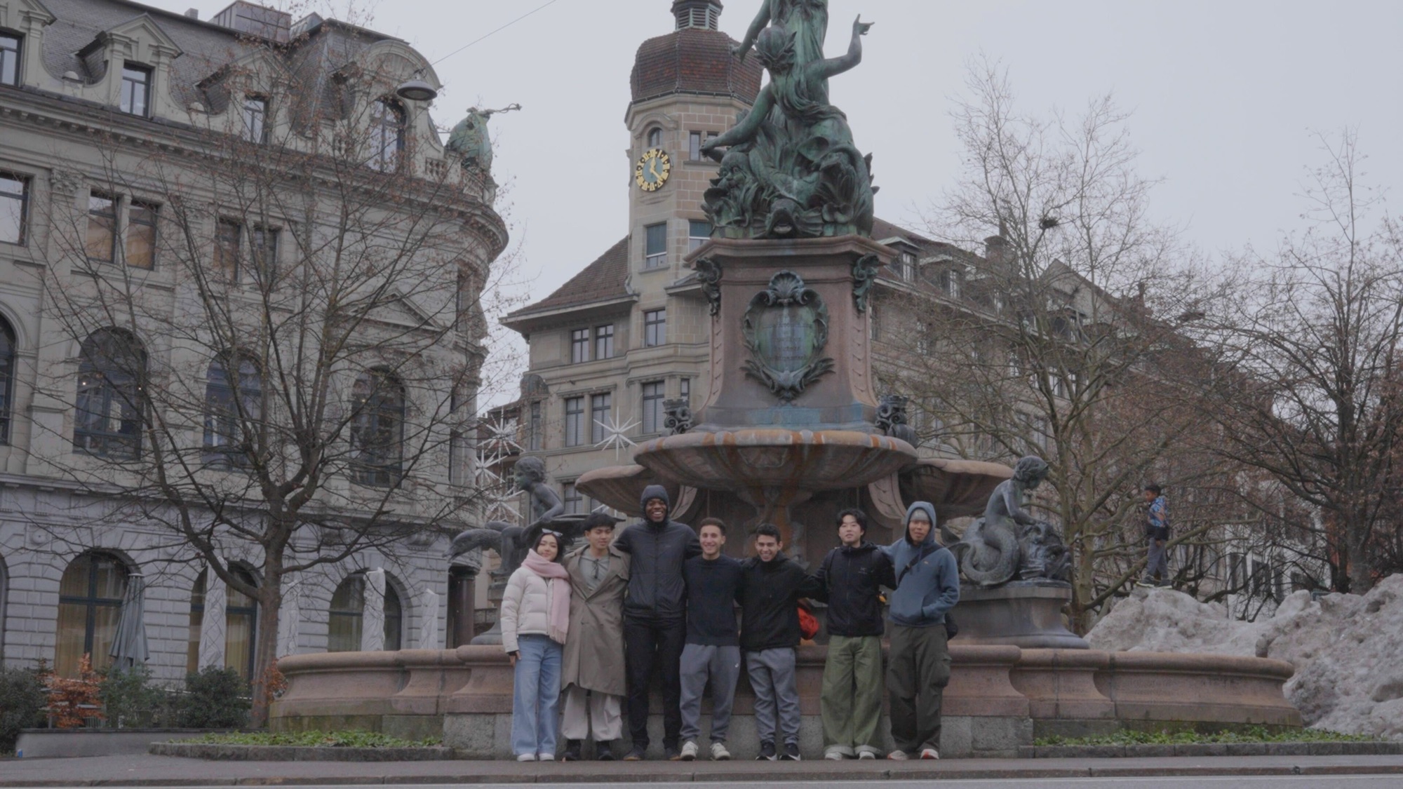 The Mira team arm in arm in front of a fountain in Zurich