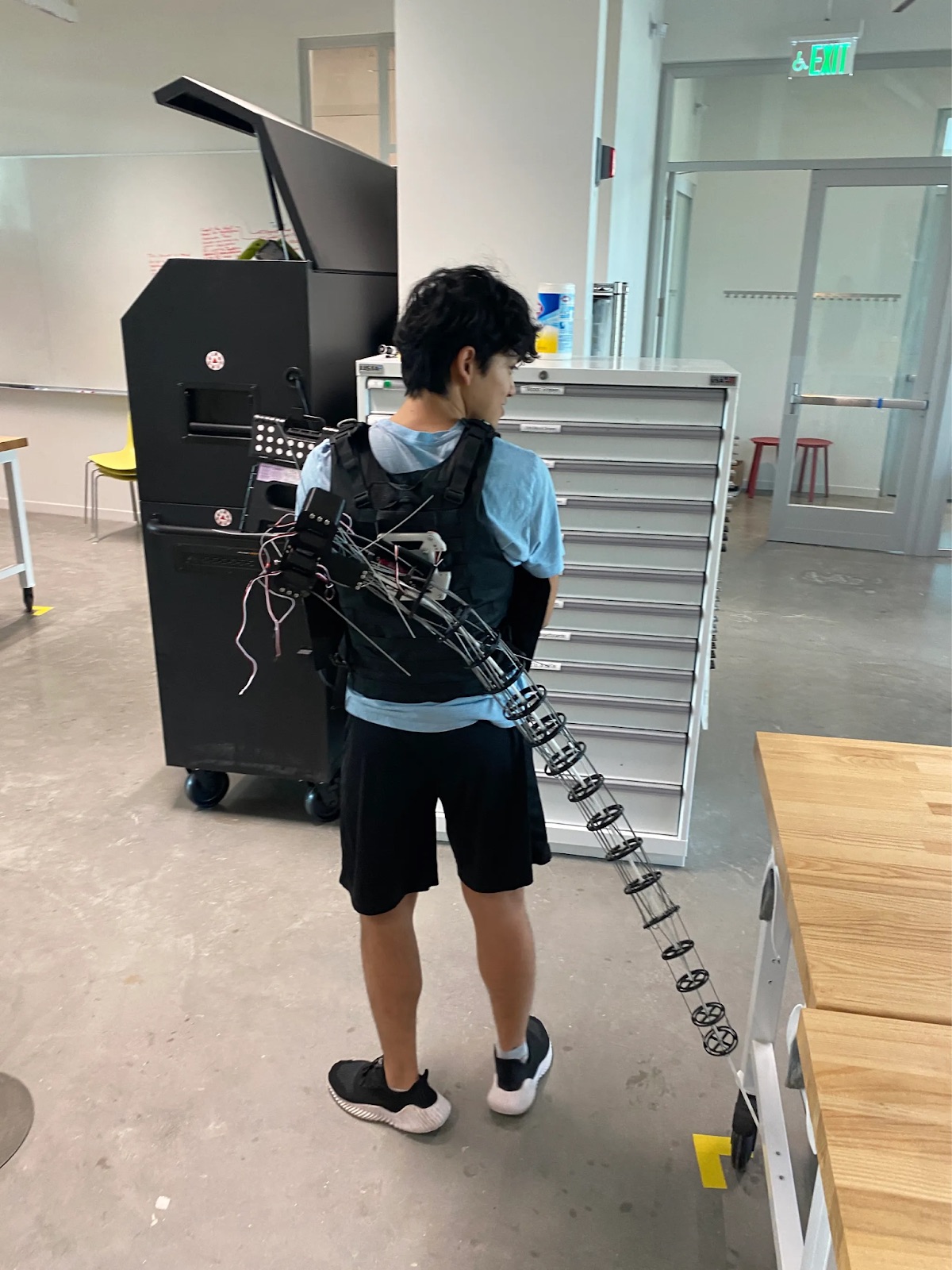 The wearable tentacle arm, strapped to a vest in the lab